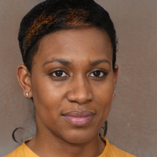 Joyful black young-adult female with short  brown hair and brown eyes