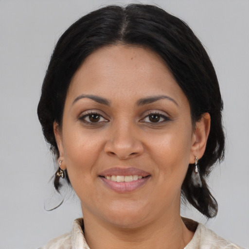 Joyful latino young-adult female with medium  brown hair and brown eyes