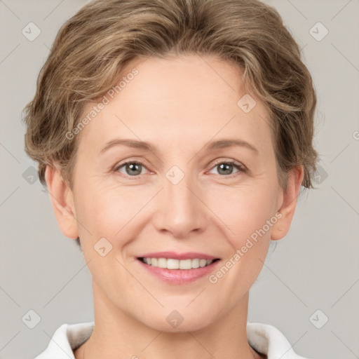 Joyful white young-adult female with short  brown hair and grey eyes