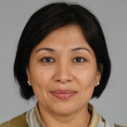 Joyful white adult female with medium  brown hair and brown eyes