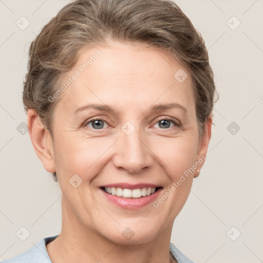 Joyful white adult female with short  brown hair and grey eyes