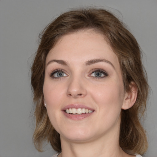 Joyful white young-adult female with medium  brown hair and grey eyes