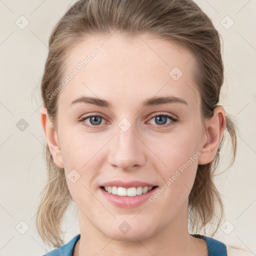 Joyful white young-adult female with medium  brown hair and blue eyes