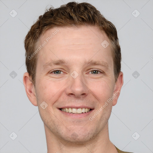 Joyful white adult male with short  brown hair and grey eyes