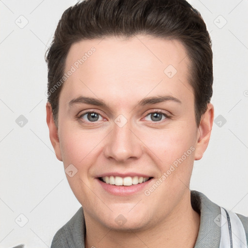 Joyful white young-adult female with short  brown hair and grey eyes