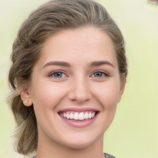 Joyful white young-adult female with medium  brown hair and green eyes