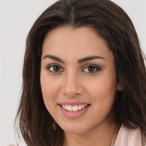 Joyful white young-adult female with long  brown hair and brown eyes
