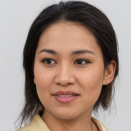 Joyful asian young-adult female with medium  brown hair and brown eyes