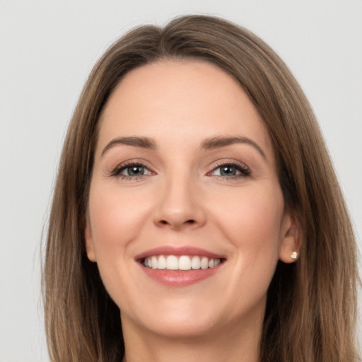 Joyful white young-adult female with long  brown hair and brown eyes