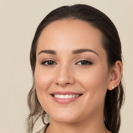 Joyful white young-adult female with long  brown hair and brown eyes