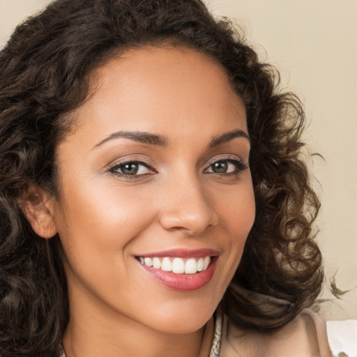 Joyful white young-adult female with long  brown hair and brown eyes