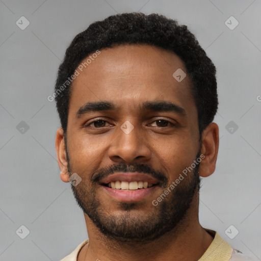 Joyful black young-adult male with short  black hair and brown eyes