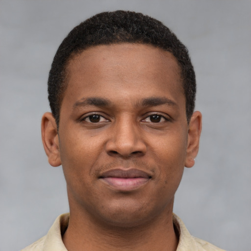 Joyful latino young-adult male with short  brown hair and brown eyes