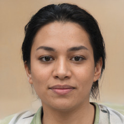 Joyful latino young-adult female with medium  brown hair and brown eyes