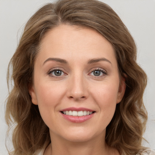 Joyful white young-adult female with medium  brown hair and green eyes