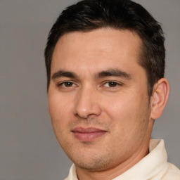 Joyful white young-adult male with short  brown hair and brown eyes
