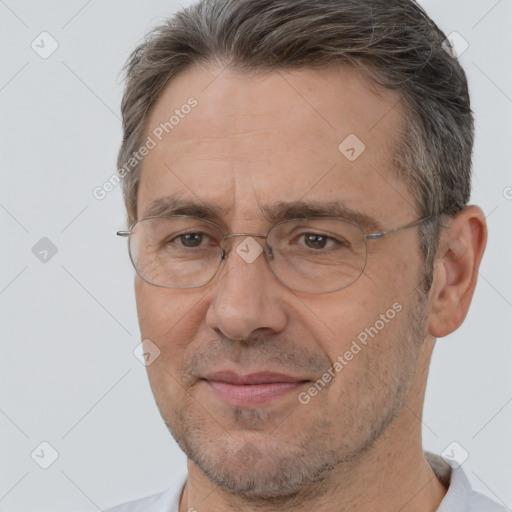 Joyful white middle-aged male with short  brown hair and brown eyes