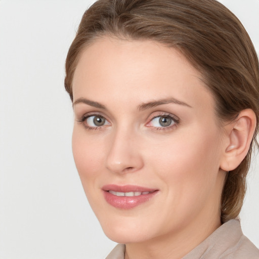 Joyful white young-adult female with long  brown hair and blue eyes