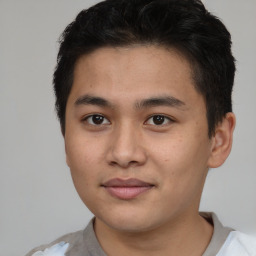 Joyful asian young-adult male with short  brown hair and brown eyes