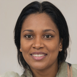 Joyful latino adult female with medium  brown hair and brown eyes