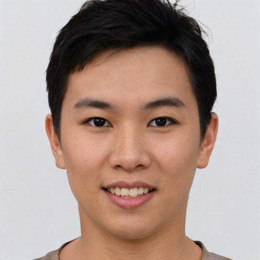 Joyful asian young-adult male with short  black hair and brown eyes