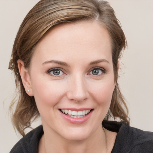 Joyful white young-adult female with medium  brown hair and blue eyes