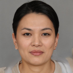 Joyful asian young-adult female with short  brown hair and brown eyes