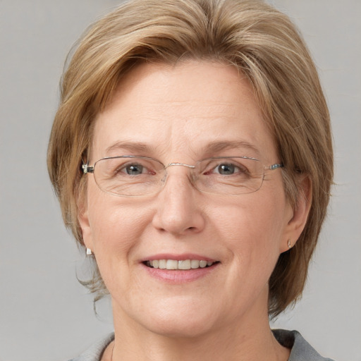 Joyful white adult female with medium  brown hair and blue eyes