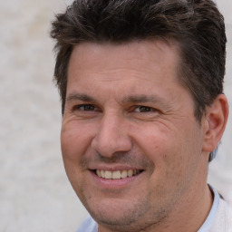 Joyful white adult male with short  brown hair and brown eyes