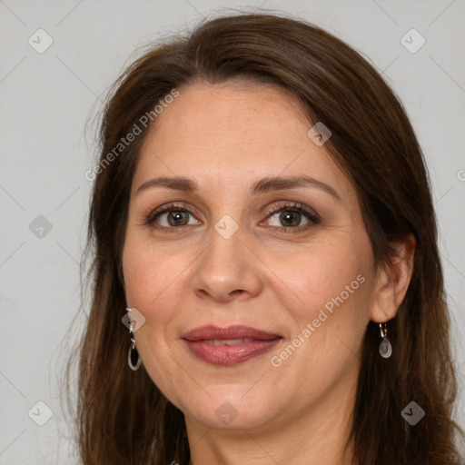 Joyful white adult female with long  brown hair and brown eyes