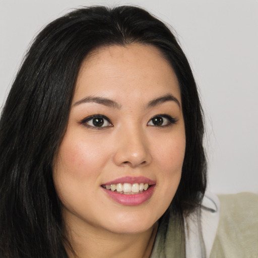 Joyful asian young-adult female with long  brown hair and brown eyes