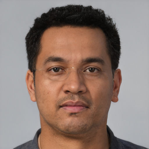 Neutral latino adult male with short  black hair and brown eyes