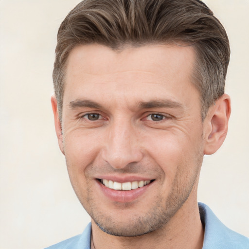 Joyful white adult male with short  brown hair and brown eyes