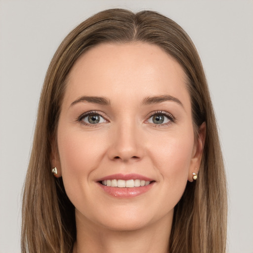 Joyful white young-adult female with long  brown hair and grey eyes