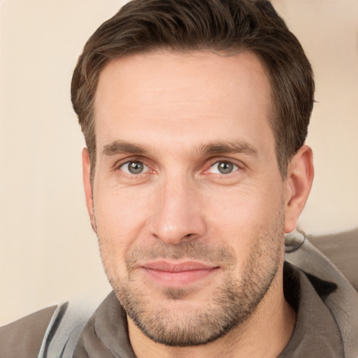 Joyful white adult male with short  brown hair and brown eyes