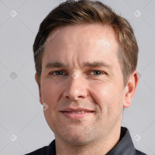 Joyful white adult male with short  brown hair and grey eyes