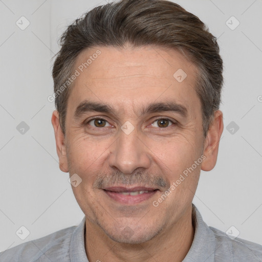 Joyful white adult male with short  brown hair and brown eyes