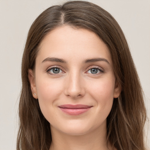 Joyful white young-adult female with long  brown hair and grey eyes