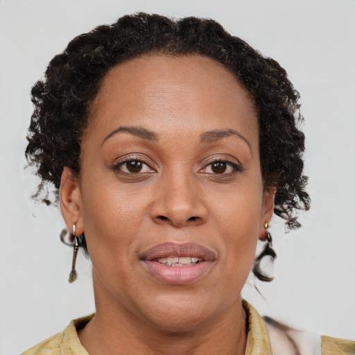 Joyful black adult female with short  brown hair and brown eyes