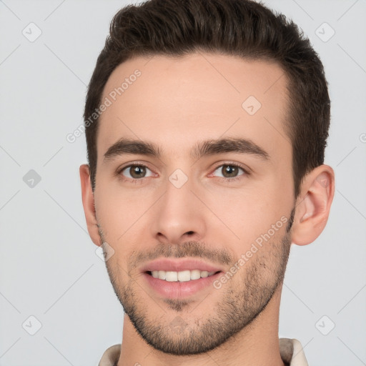 Joyful white young-adult male with short  brown hair and brown eyes