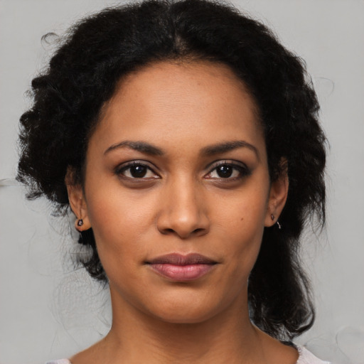 Joyful latino young-adult female with medium  black hair and brown eyes