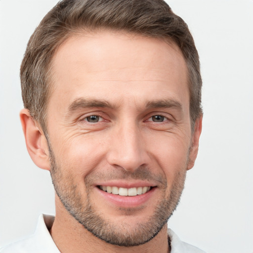 Joyful white adult male with short  brown hair and brown eyes