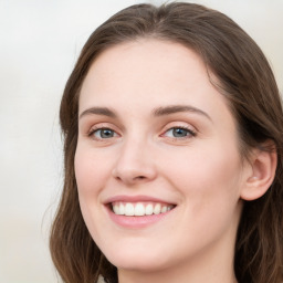 Joyful white young-adult female with long  brown hair and green eyes