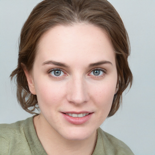 Joyful white young-adult female with medium  brown hair and blue eyes