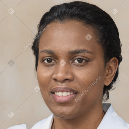 Joyful black young-adult female with short  black hair and brown eyes