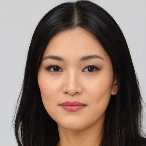 Joyful asian young-adult female with long  black hair and brown eyes