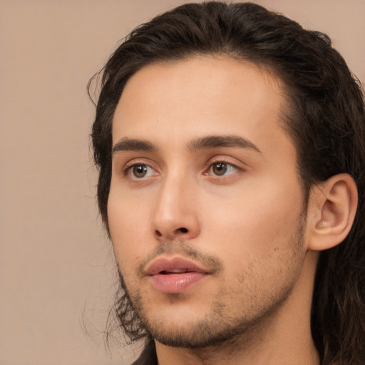 Neutral white young-adult male with long  brown hair and brown eyes