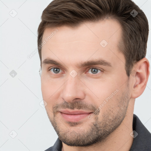 Joyful white adult male with short  brown hair and brown eyes