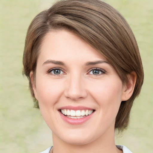 Joyful white young-adult female with medium  brown hair and green eyes