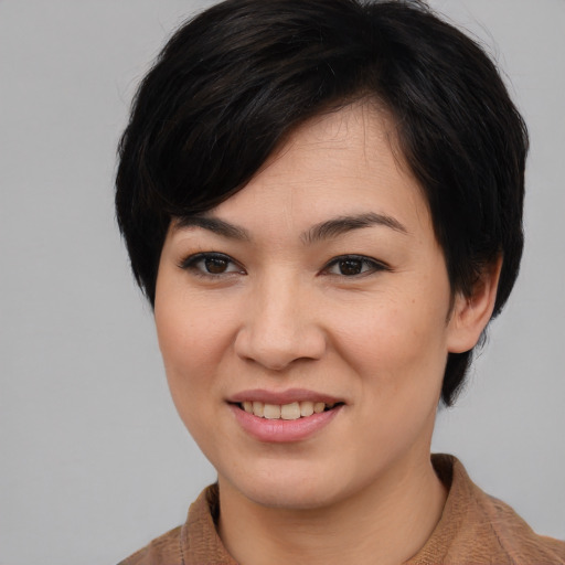 Joyful asian young-adult female with medium  brown hair and brown eyes